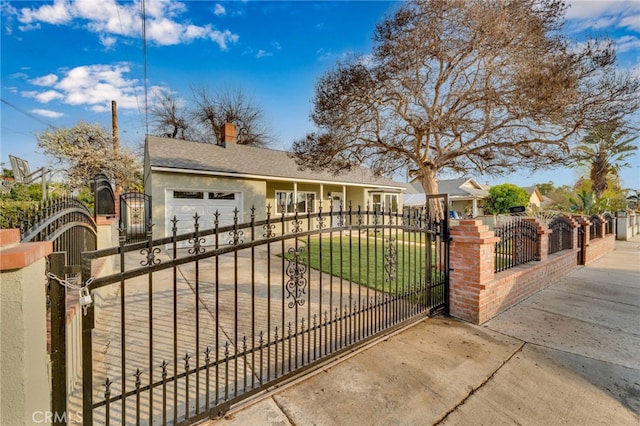 view of gate with a garage