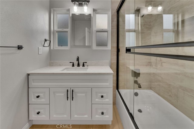 bathroom with vanity and enclosed tub / shower combo