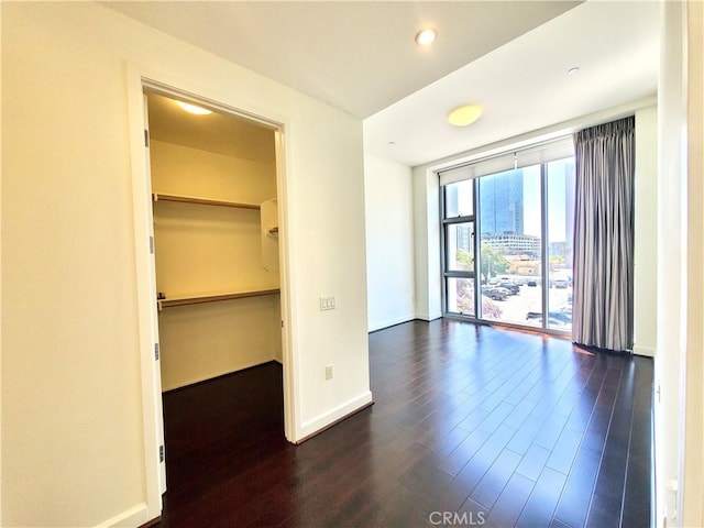 empty room with dark hardwood / wood-style floors