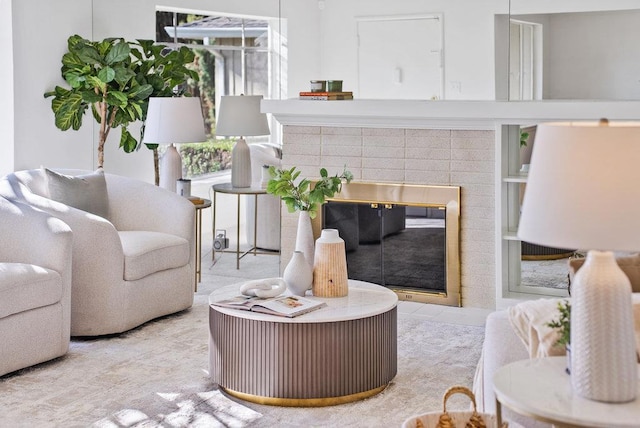 living room with a brick fireplace