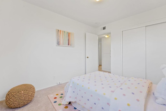 bedroom with carpet floors and a closet