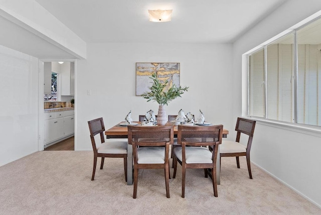 dining area featuring light colored carpet