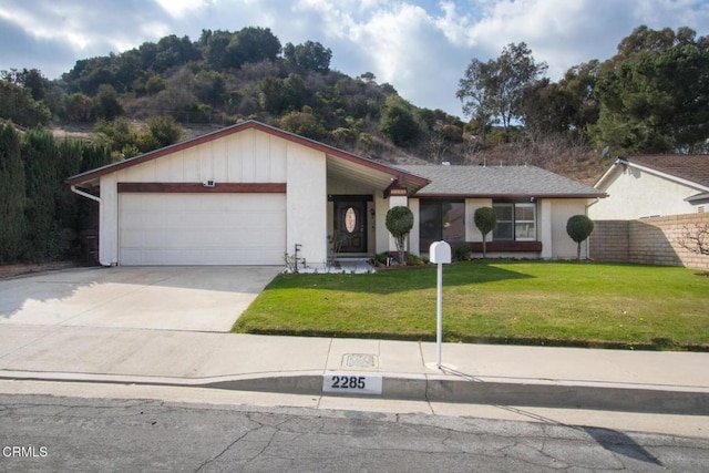 single story home with a garage and a front yard