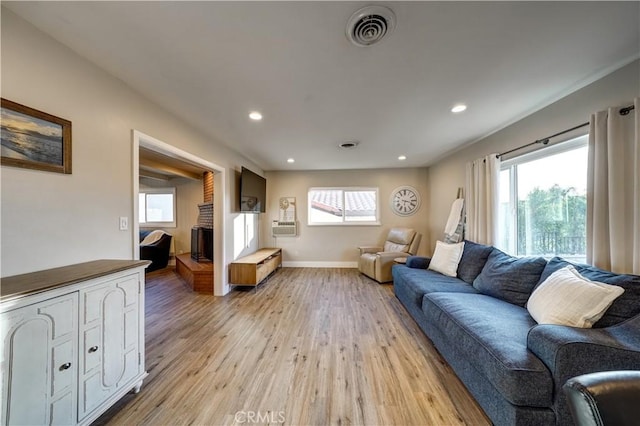 living room featuring recessed lighting, visible vents, light wood-style flooring, and baseboards