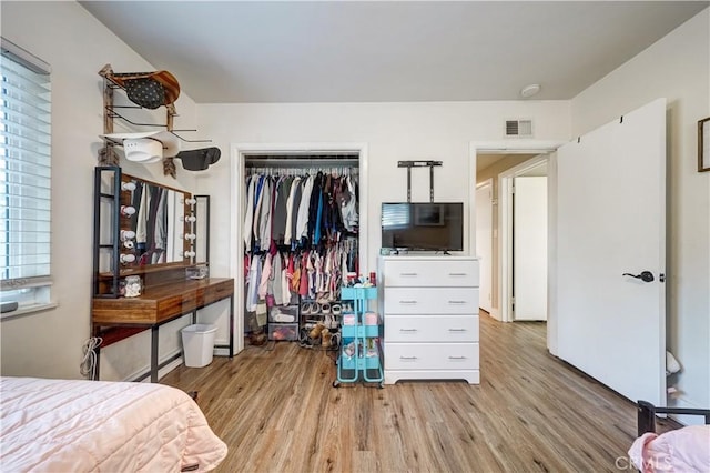 bedroom with a closet and light hardwood / wood-style flooring