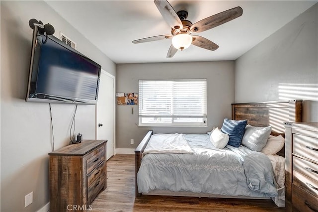 bedroom with wood-type flooring and ceiling fan