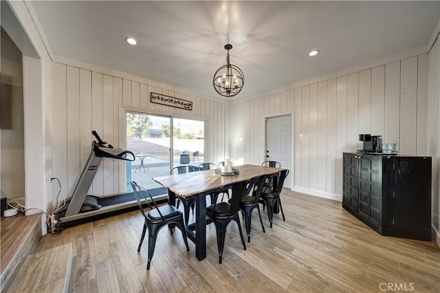 dining space with an inviting chandelier and light hardwood / wood-style floors