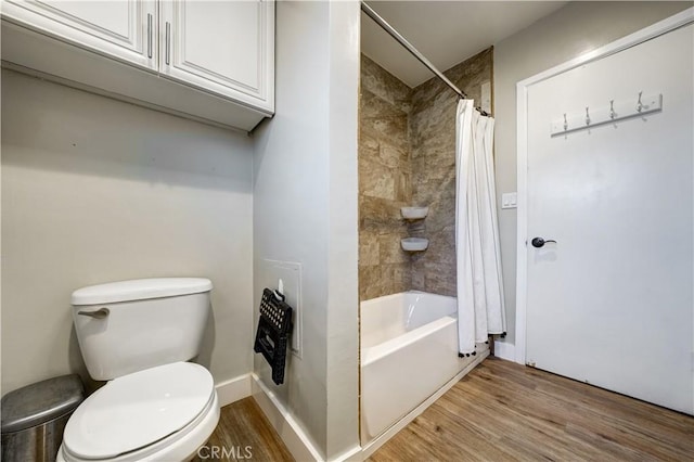 bathroom featuring hardwood / wood-style flooring, shower / bath combo, and toilet