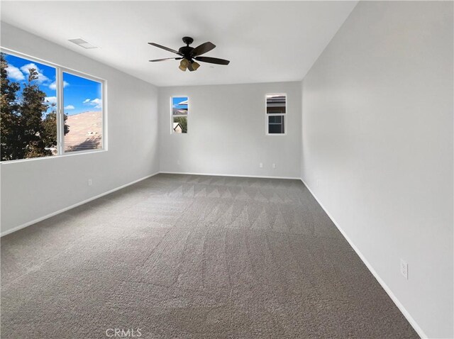 carpeted empty room featuring ceiling fan