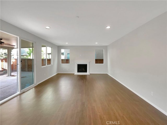 unfurnished living room with dark wood-type flooring