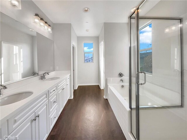 bathroom with vanity, wood-type flooring, and separate shower and tub