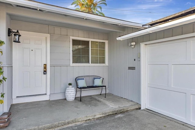 doorway to property with a garage