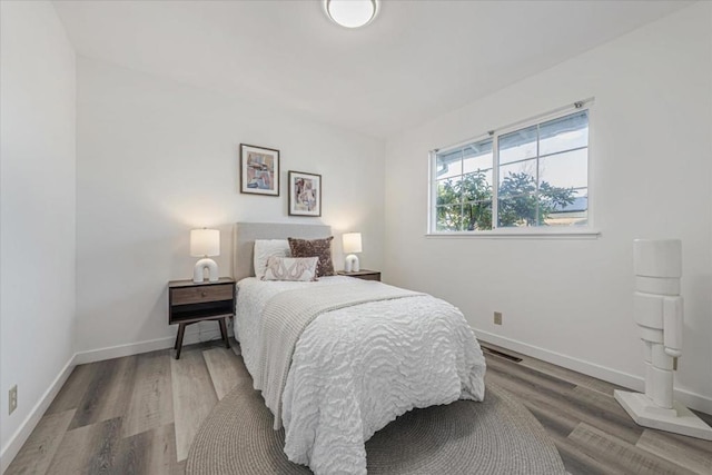 bedroom with hardwood / wood-style floors