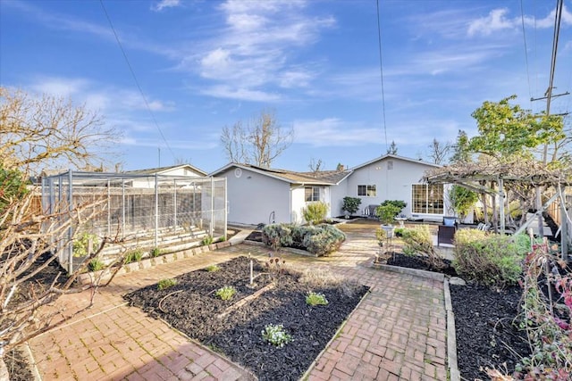 rear view of house with a pergola