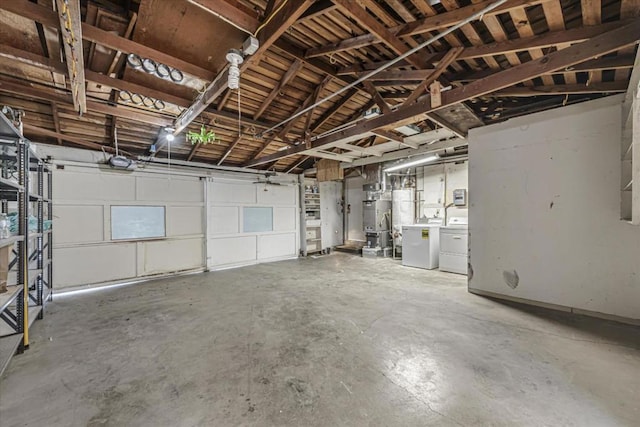 garage with washing machine and dryer and water heater