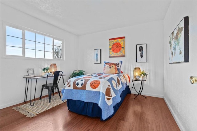 bedroom with hardwood / wood-style floors