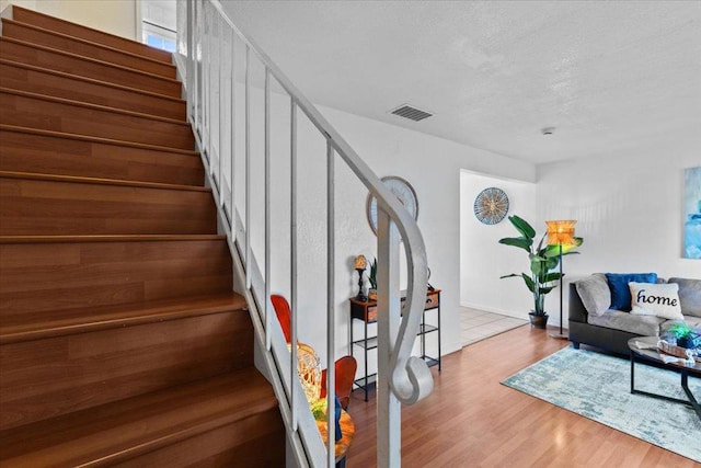 living room featuring hardwood / wood-style floors and a textured ceiling