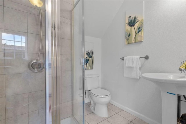 bathroom with tile patterned flooring, toilet, and walk in shower