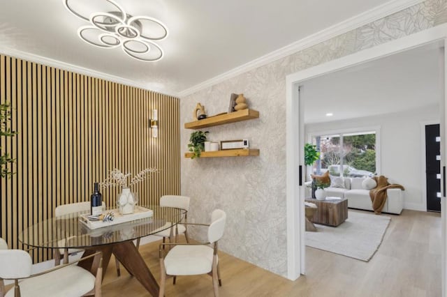 dining area featuring ornamental molding and light wood-type flooring