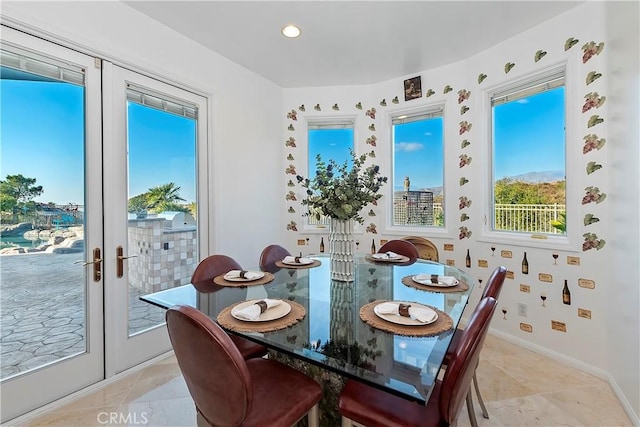 tiled dining room featuring french doors