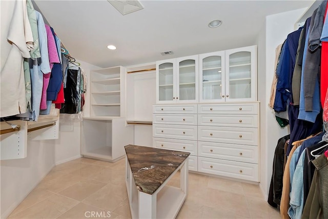 spacious closet with light tile patterned floors