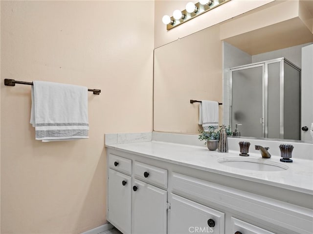 bathroom with vanity and a shower with shower door