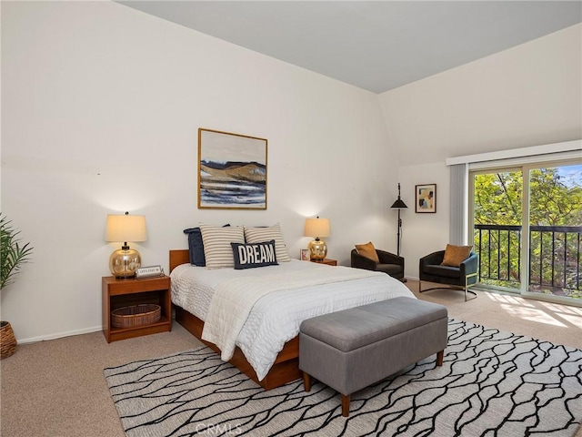 bedroom featuring light carpet, access to exterior, and lofted ceiling