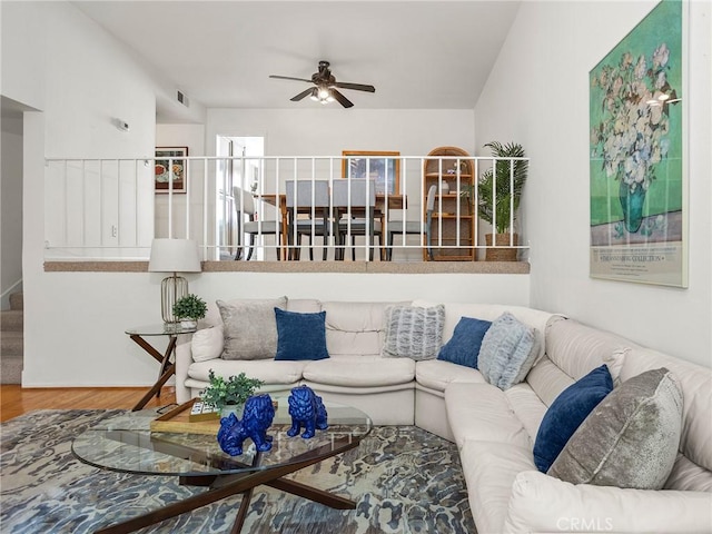 living room with hardwood / wood-style floors and ceiling fan