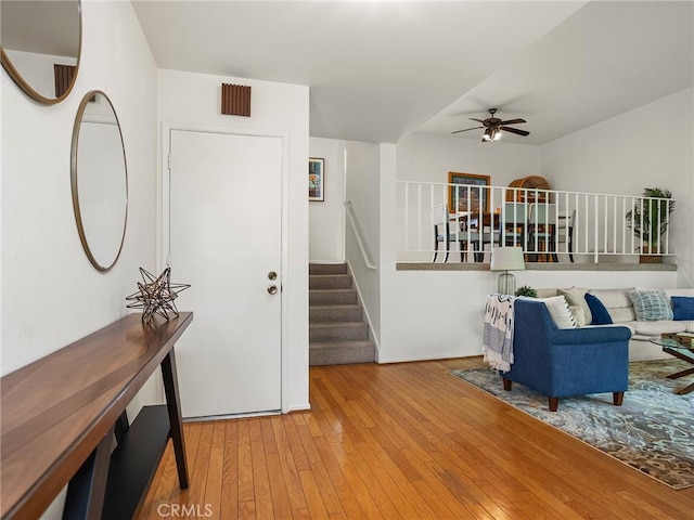 living room featuring hardwood / wood-style floors and ceiling fan