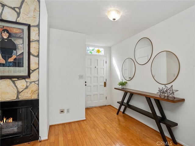 entryway featuring a fireplace and hardwood / wood-style floors