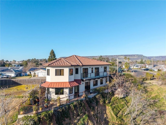 mediterranean / spanish home with a balcony