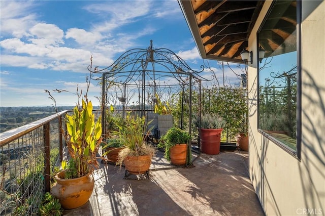 view of patio featuring a balcony