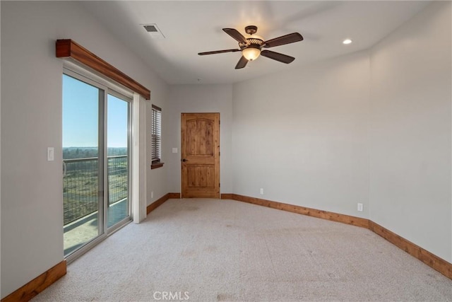 spare room featuring light carpet and ceiling fan