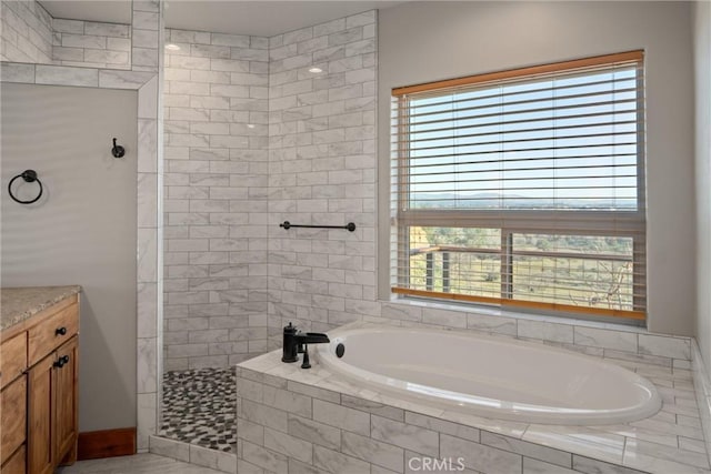 bathroom with vanity and independent shower and bath