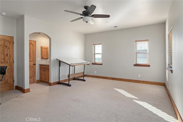 spare room featuring plenty of natural light and ceiling fan