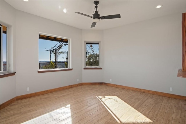 empty room with ceiling fan and light wood-type flooring