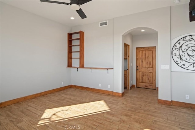 spare room with ceiling fan and light hardwood / wood-style flooring