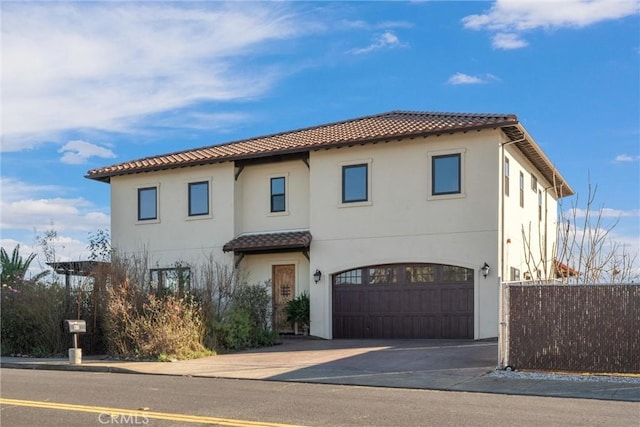 mediterranean / spanish-style home featuring a garage