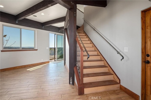 stairs with beam ceiling and wood-type flooring