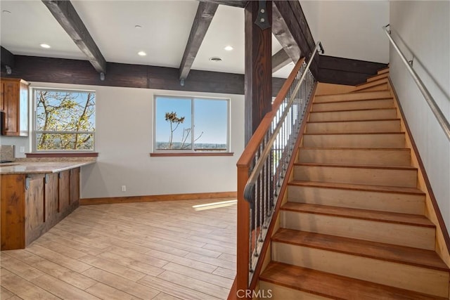 stairway featuring hardwood / wood-style flooring and beam ceiling