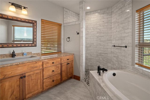 bathroom featuring vanity and separate shower and tub