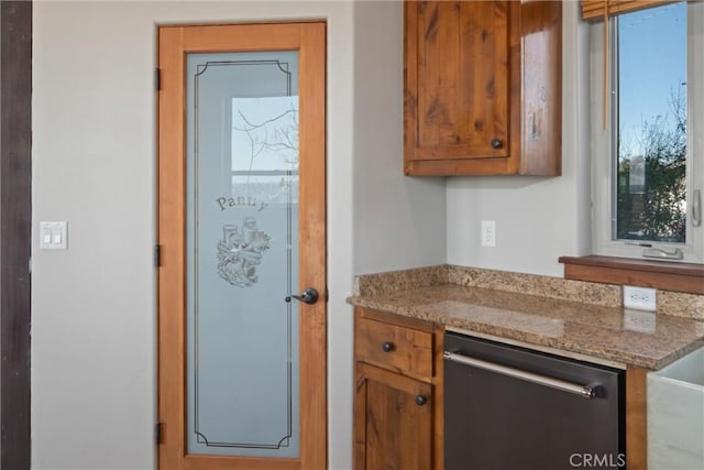 kitchen with stone countertops and stainless steel dishwasher