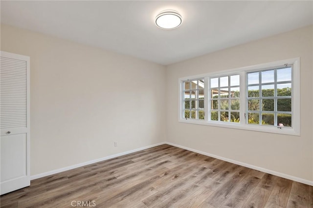 spare room with hardwood / wood-style floors