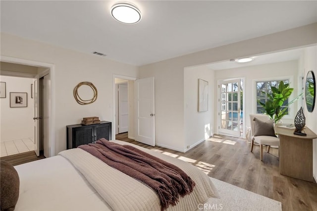 bedroom featuring light hardwood / wood-style floors and access to outside