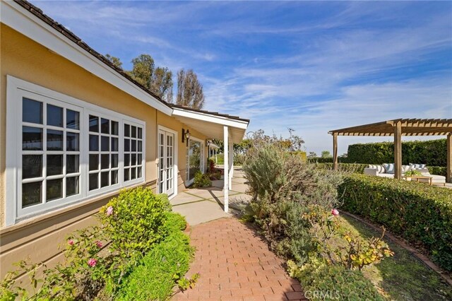 view of yard featuring a pergola, a patio area, and french doors