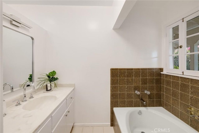 bathroom featuring vanity, tile patterned flooring, and a washtub