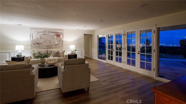 living room featuring crown molding, dark wood-type flooring, and french doors