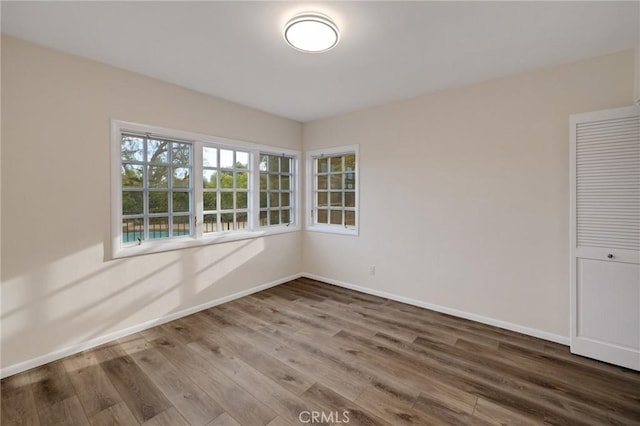 unfurnished room with hardwood / wood-style floors