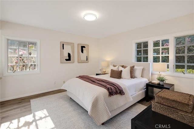 bedroom featuring light hardwood / wood-style floors and multiple windows