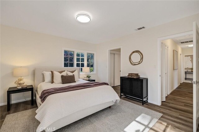 bedroom with dark hardwood / wood-style floors